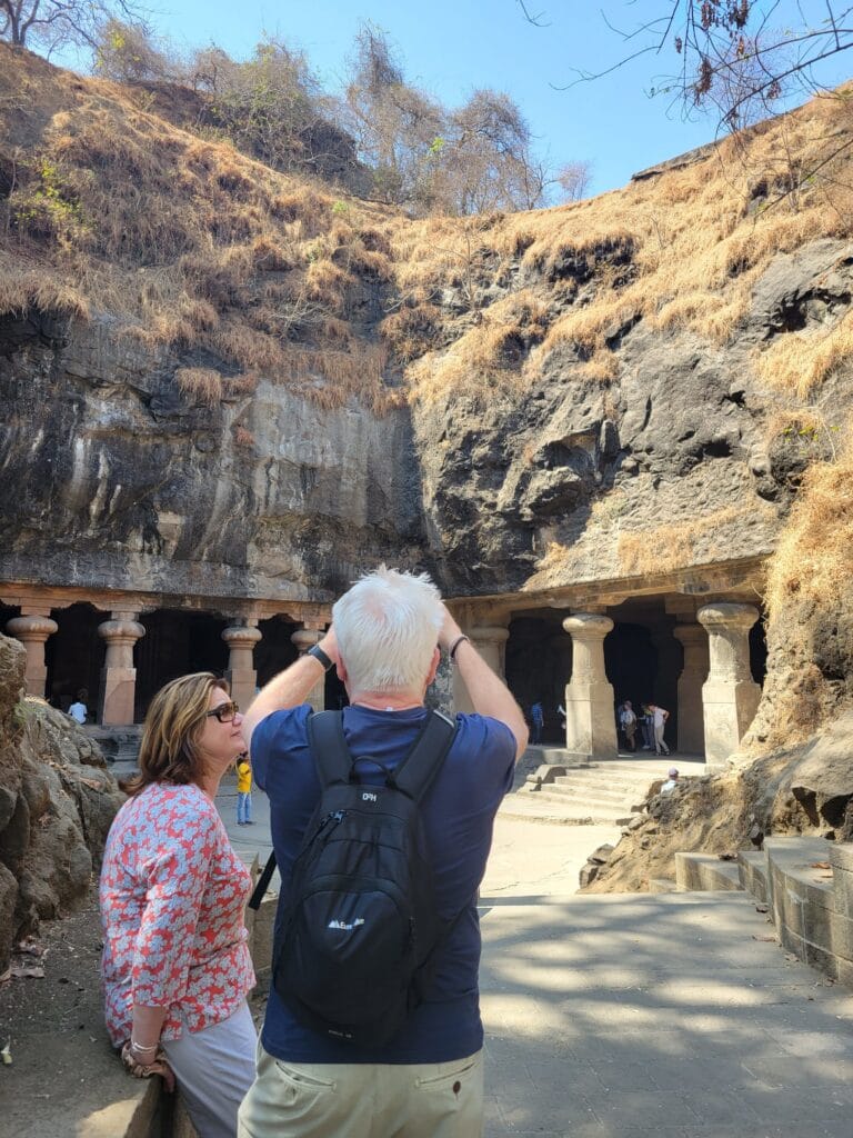 entrance view of Elephanta Caves Mumbai with rock cut pillars and visitors