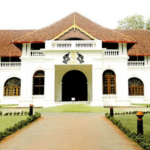 Traditional Kerala heritage palace with tiled roof and colonial architecture