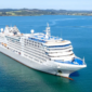 Luxury cruise ship sailing in blue ocean during international voyage, ideal for shore excursions in India