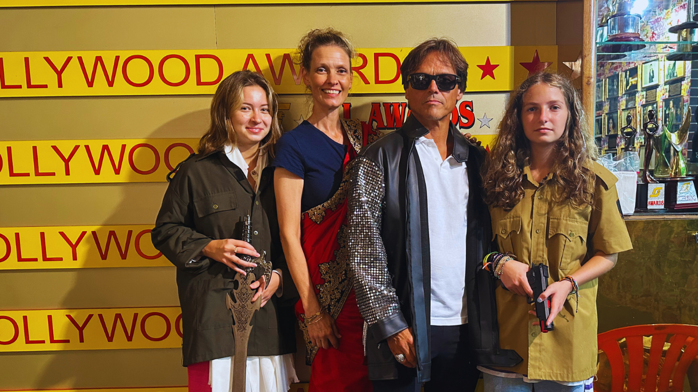 Group of visitors posing with a Bollywood actor statue at a film awards–themed exhibit