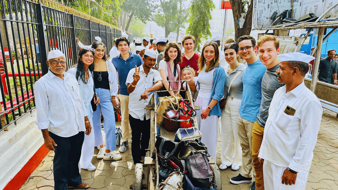 Travelers interacting with local Mumbai workers during a cultural Highlights of Mumbai guided city tour