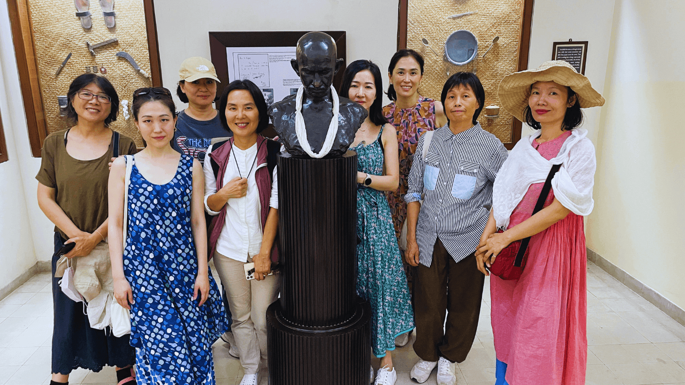 Travelers visiting Mahatma Gandhi museum exhibit during Highlights of Mumbai guided heritage tour