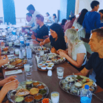Travelers enjoying traditional Indian lunch during a guided Mumbai sightseeing tour experience