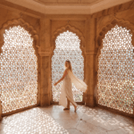 Traveler inside a Mughal heritage monument experiencing intricate jali architecture during a Golden Triangle shore excursion in India