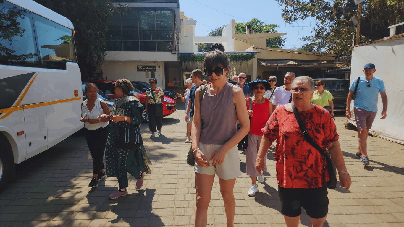 Travel group walking with local guide during a Mumbai guided city sightseeing tour