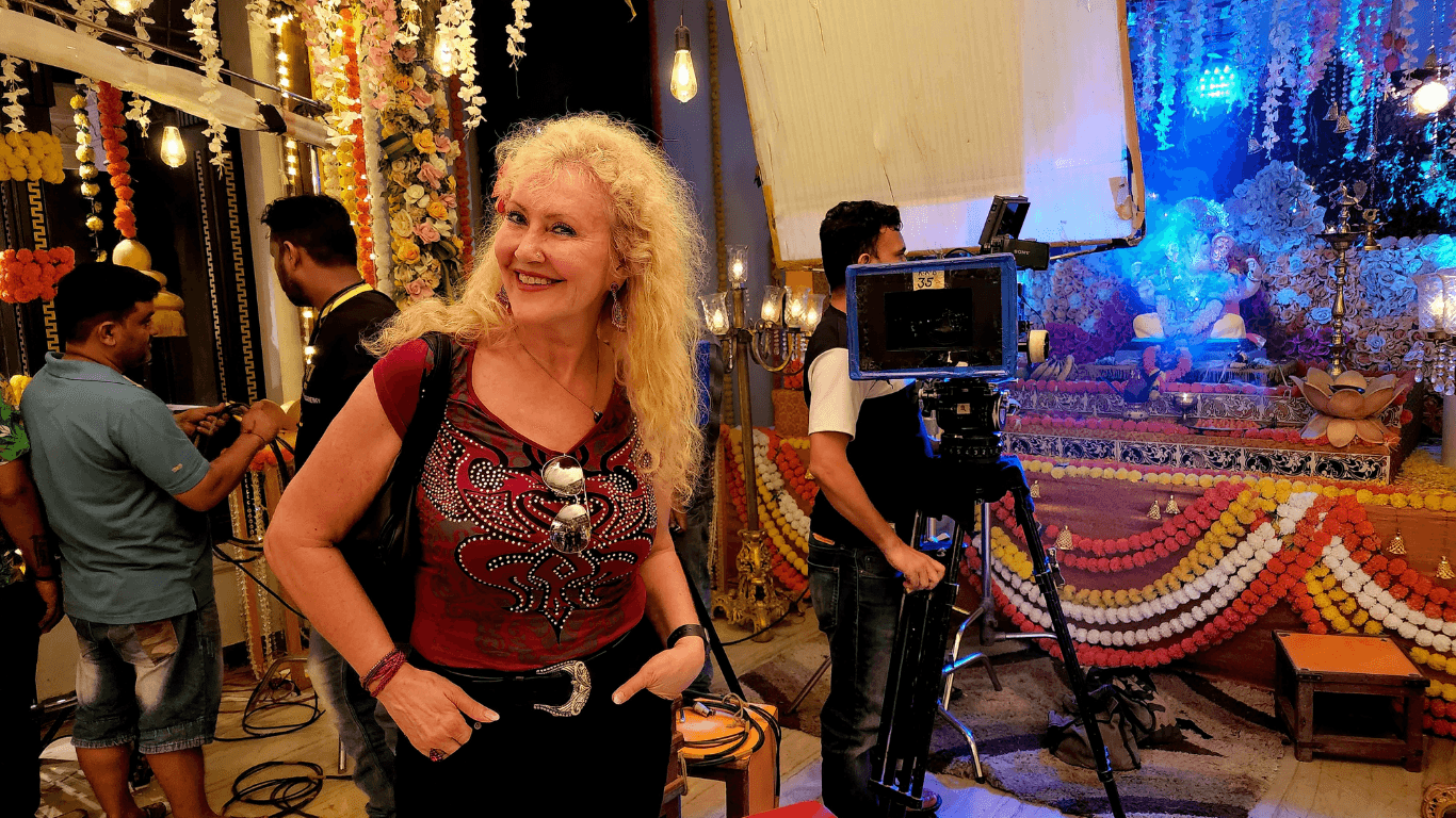 Tourist visiting Bollywood film set in Mumbai studio during guided city tour