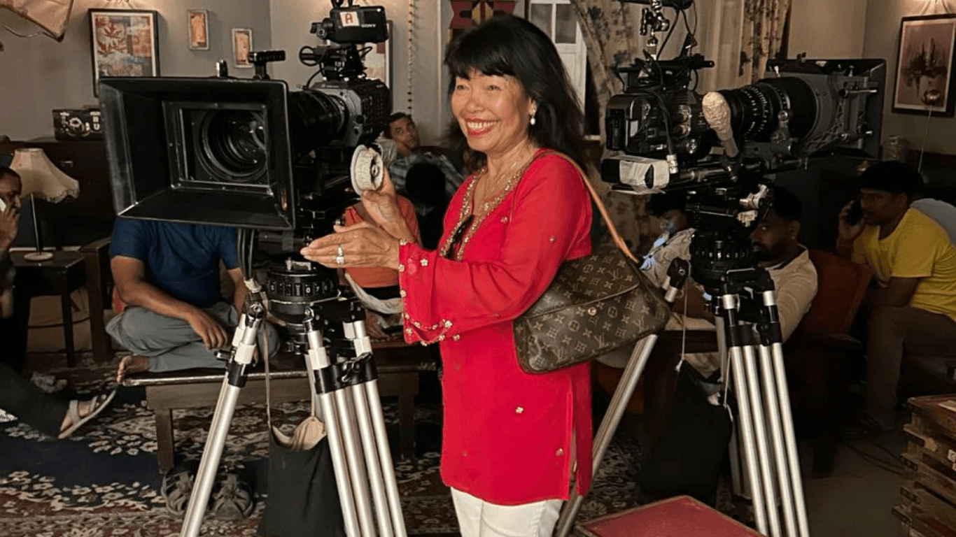 Tourist interacting with professional movie cameras at a Bollywood film studio in Mumbai