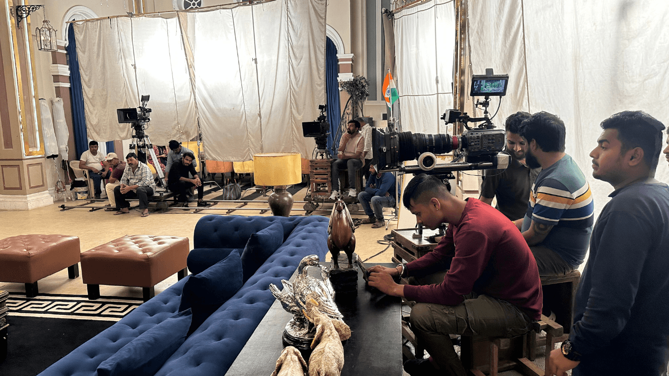 Film crew and cinema cameras set up inside a Mumbai movie studio during a Bollywood shoot
