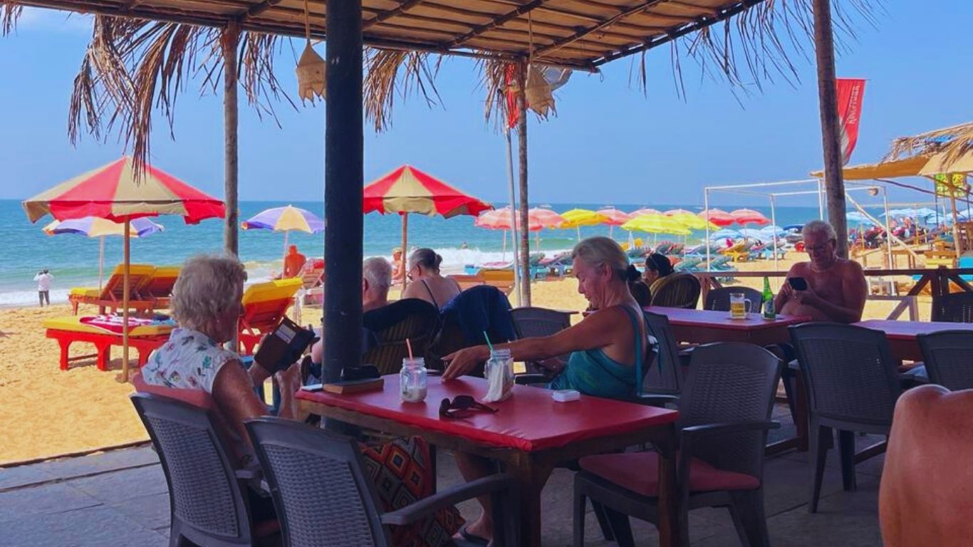 Beach shack café at Candolim Beach Goa with sunbeds, umbrellas and ocean view