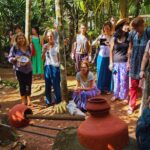 Tourists listening to a guide at a traditional spice plantation in Goa