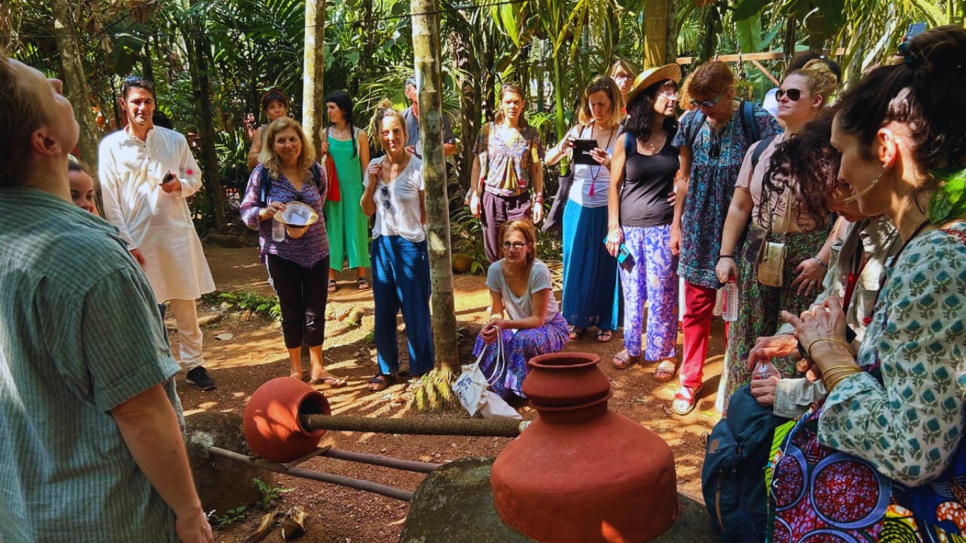 Tourists listening to a guide at a traditional spice plantation in Goa
