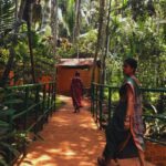 Local woman walking through a spice plantation village in Goa