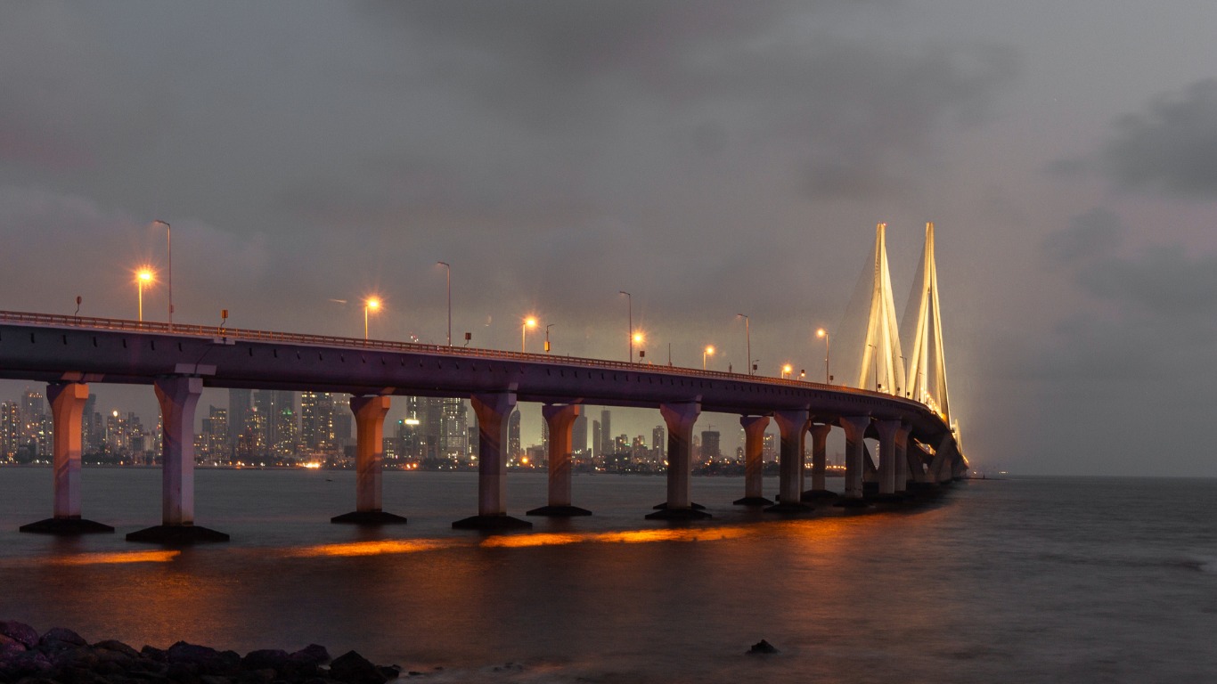 Bandra Worli Sea Link illuminated at night with Mumbai skyline and Arabian Sea
