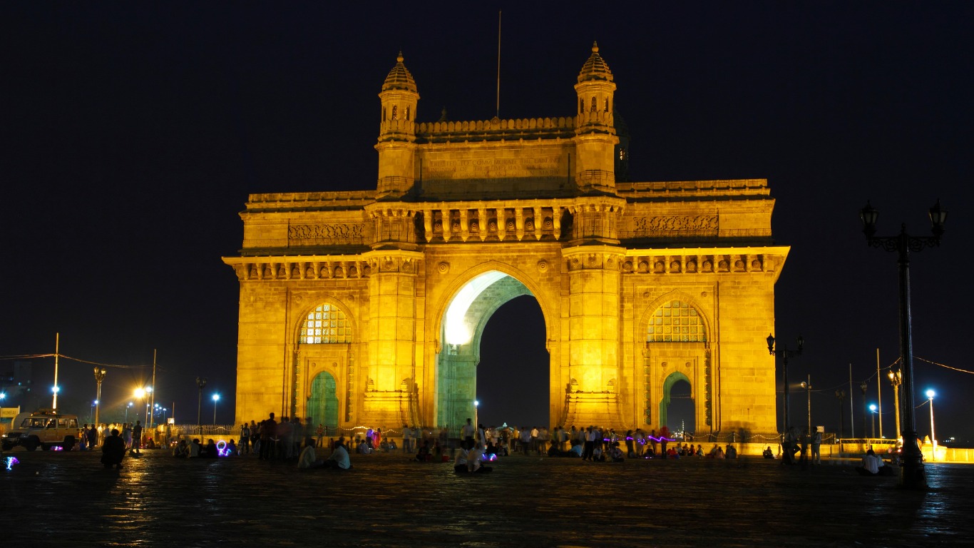 Gateway of India illuminated at night with visitors and city lights Mumbai