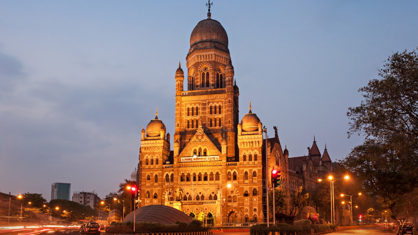 Brihanmumbai Municipal Corporation building illuminated at night with traffic light trails in Mumbai
