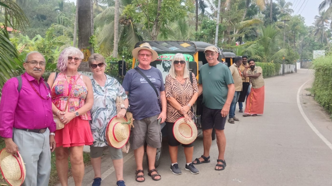 Tourists interacting with locals during a guided village walk in Kumbalangi near Kochi