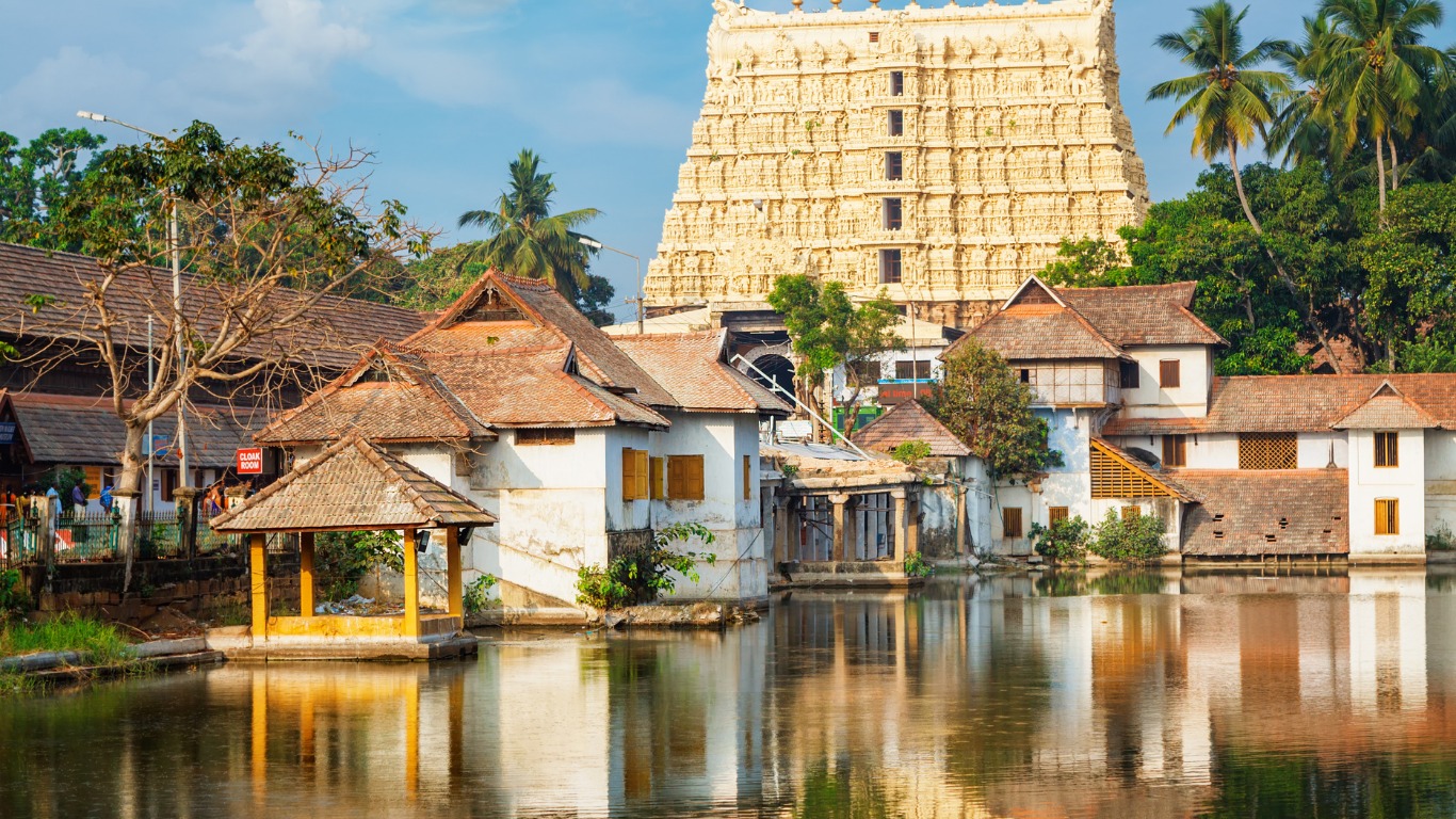 Traditional Kerala temple and village houses reflected in water at Kumbalangi near Kochi