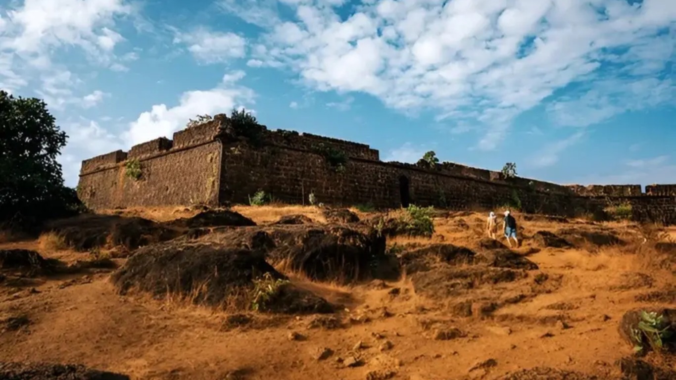 Traditional Portuguese-style Goan house with tiled roof and tropical surroundings