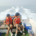 International travelers enjoying premium speedboat transfer to Elephanta Caves from Mumbai, reducing travel time to just 20 minutes.