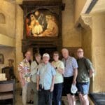 Small group of travelers posing inside a historic heritage interior during a cultural sightseeing experience in Mumbai.