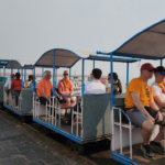 Visitors riding the Elephanta Island toy train after arriving on a luxury Elephanta Caves private speedboat tour