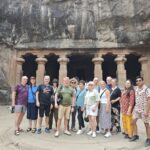 Tour group at Elephanta Caves Mumbai with guide on a speedboat tour from Gateway of India