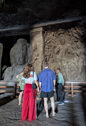 Professional guide explaining the history and sculptures inside Elephanta Caves